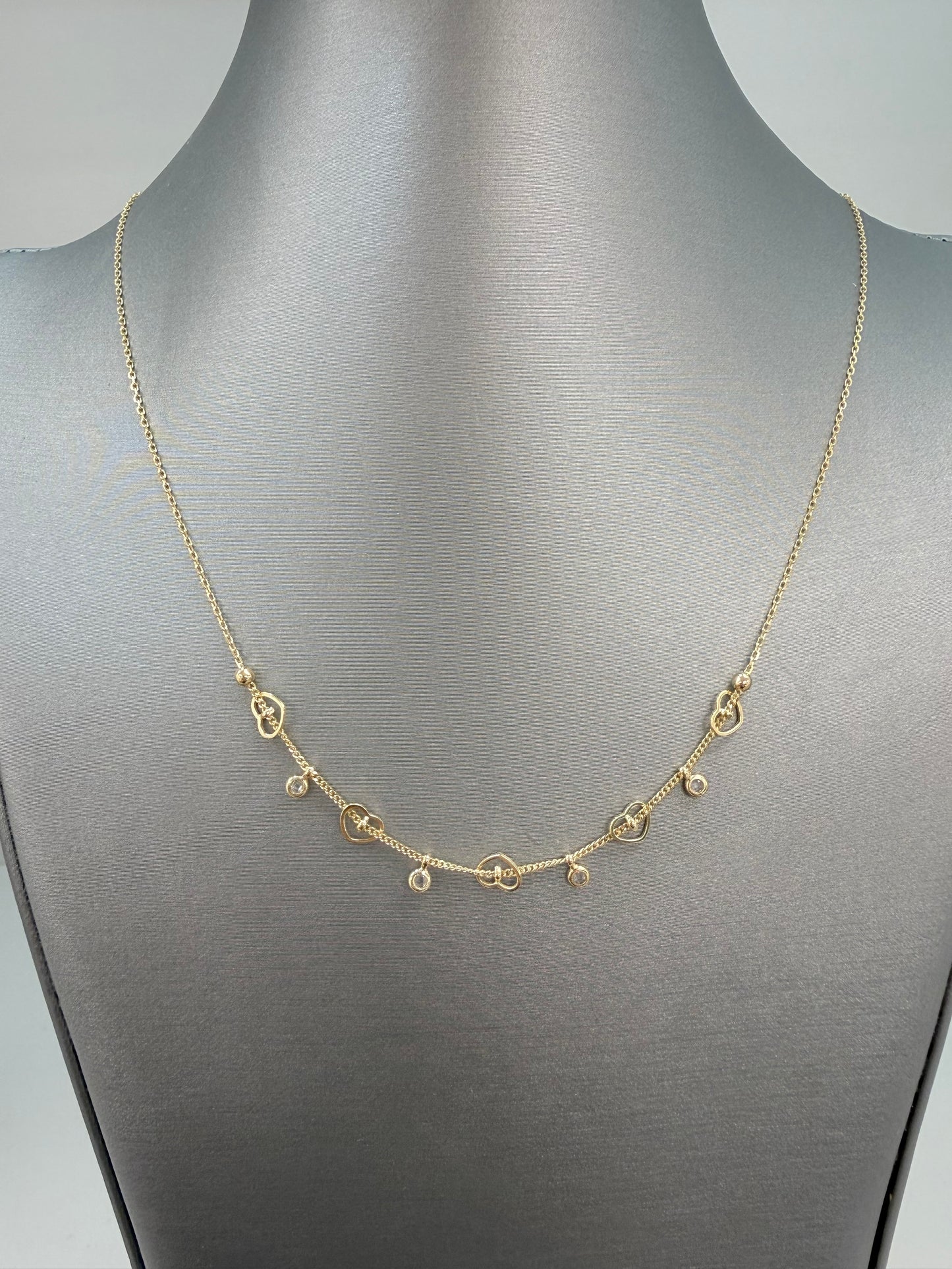Cadena solida de corazones y circonias en oro de 14 kt