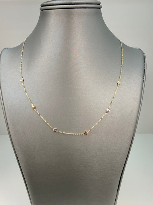 Cadena solida con diseño de corazones en oro blanco y amarillo en 14 kt